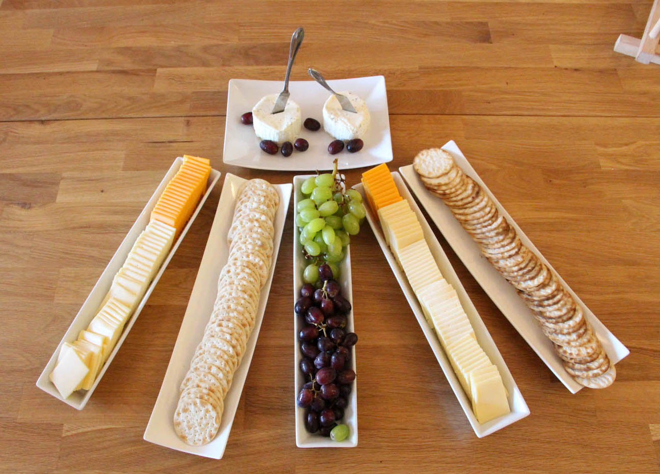 An assorted cheese platter with a side of crackers at The Real Food Academy.