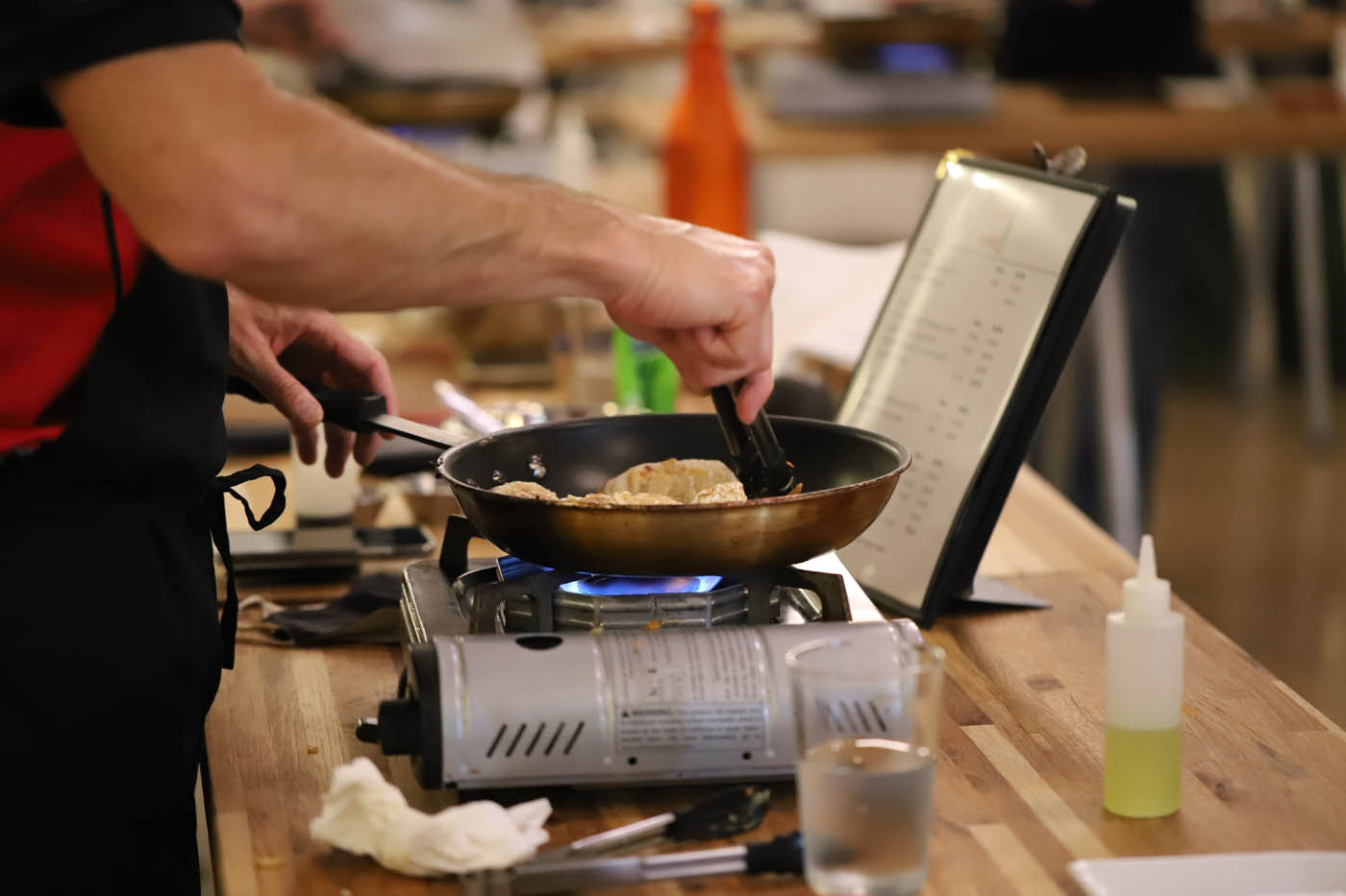 A corporate team cooking fresh pot stickers at our corporate party venue in Orlando, FL.