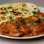 The Real Food Academy Orlando chicken tikka masala with a side of naan.