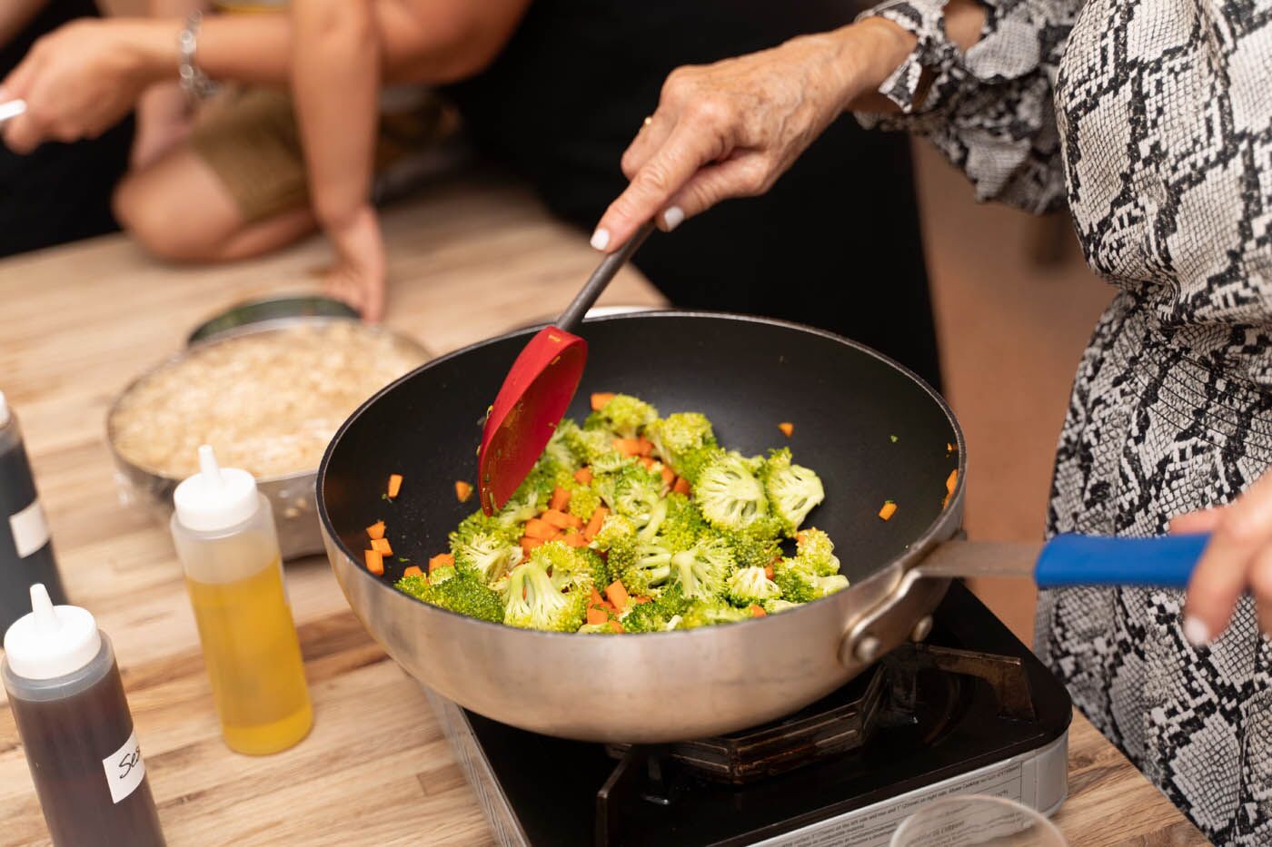 A corporate team memeber making fresh vegatibles at The Real Food Academy Miami's corporate experience.