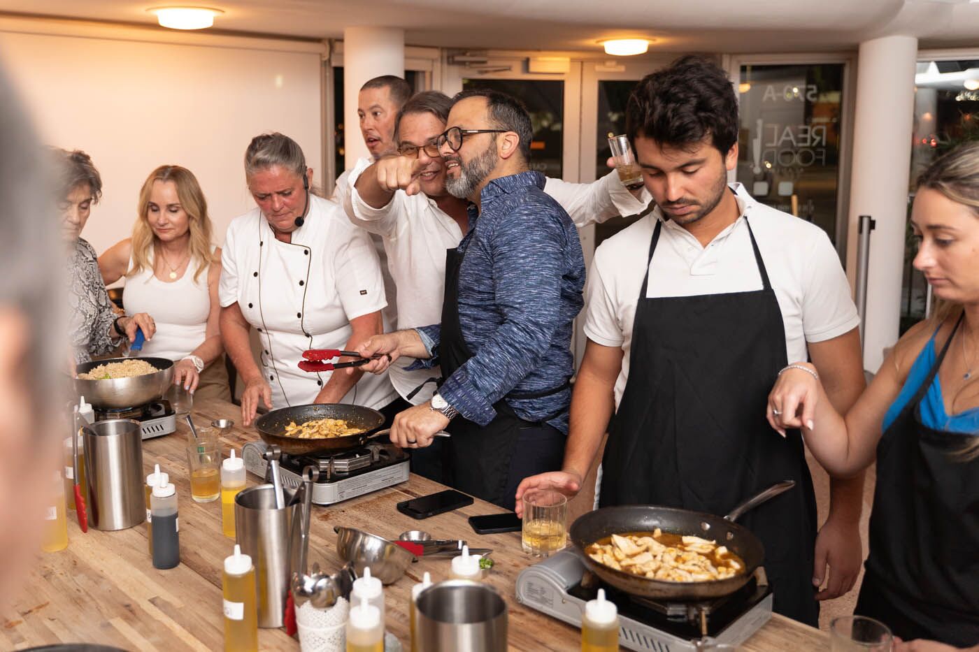 A group of team members drinking and laughing at The Real Food Academy's corporate party venue in Orlando, FL. 