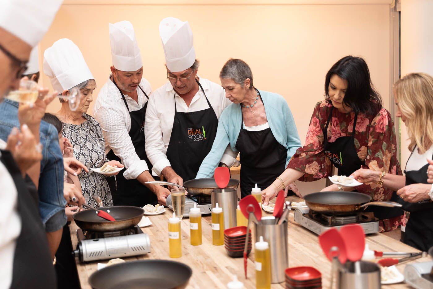A group of team members cooking their meal led by our The Real Food Academy chef, check out our corporate party venues in Orlando, FL.