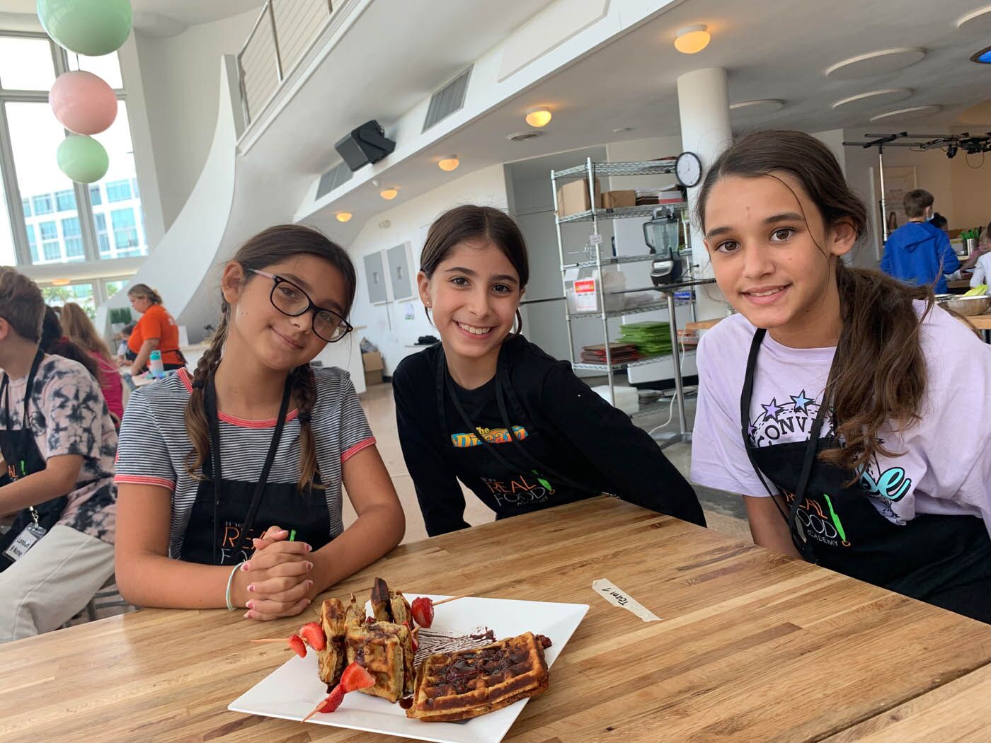Kids cooking camp with The Real Food Academy Miami - three girls showing off their creation!
