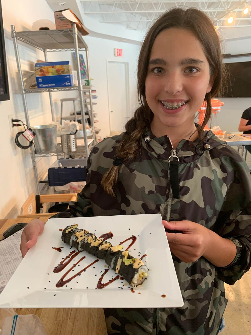 A teen with their delicious sushi creation at The Real Food Academy Miami's teen cooking camp.