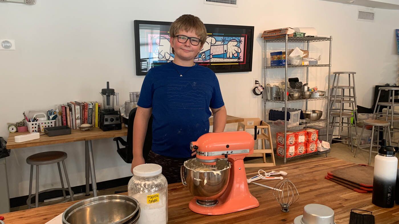 A boy mixing up magic at The Real Food Academy Miami's kids cooking camp.