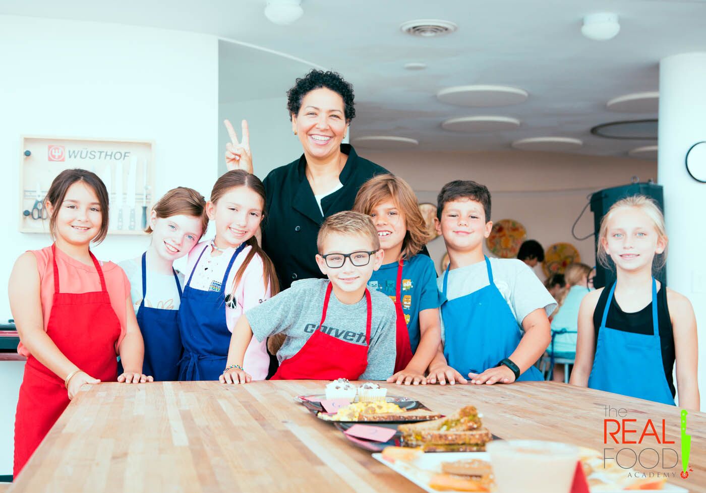 A chef with a group of kids with fresh made sandwiches at The Real Food Academy's after school program in Orlando, FL.