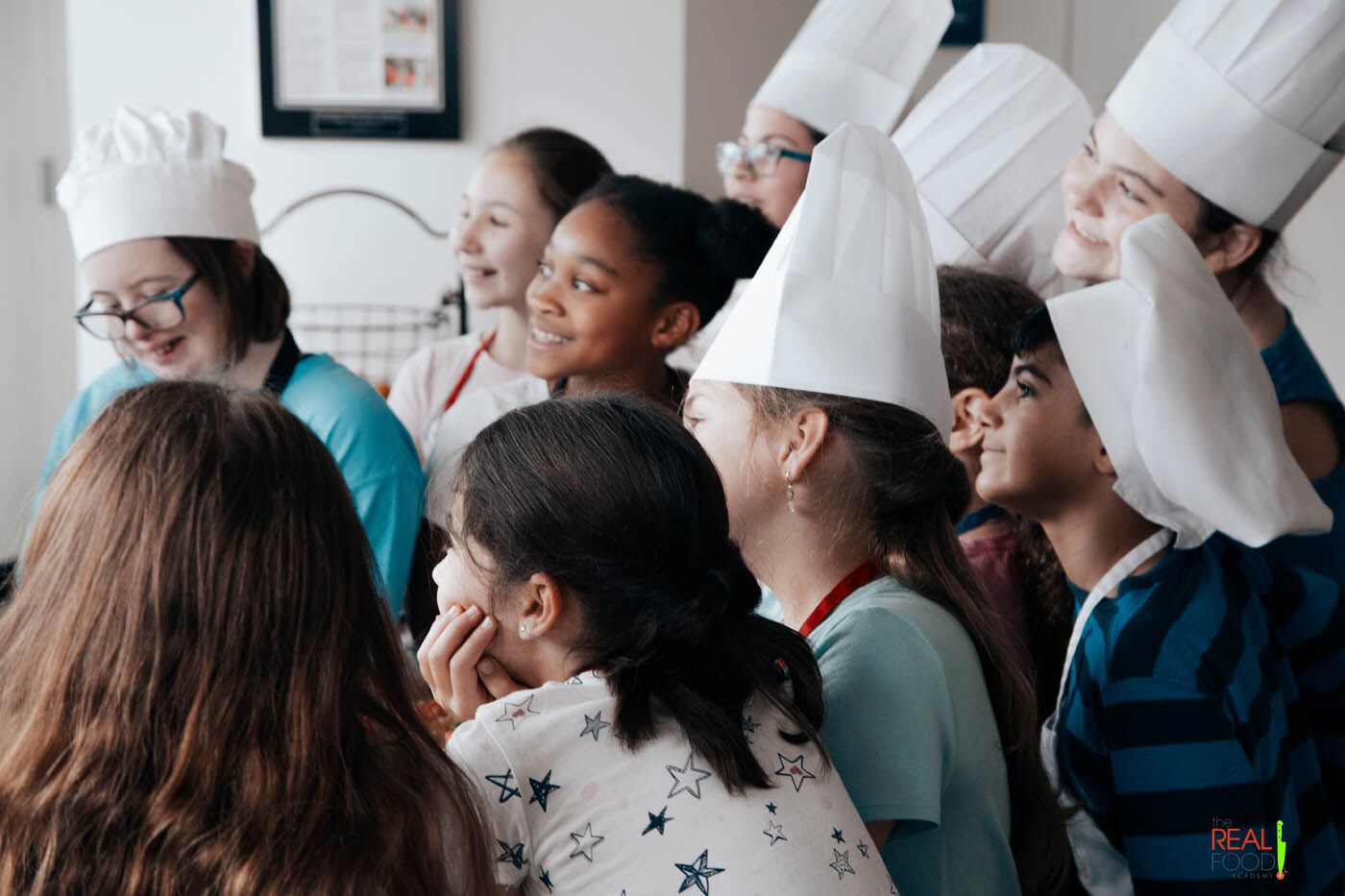A group of eager young chefs as a The Real Food Academy Miami cooking camp.