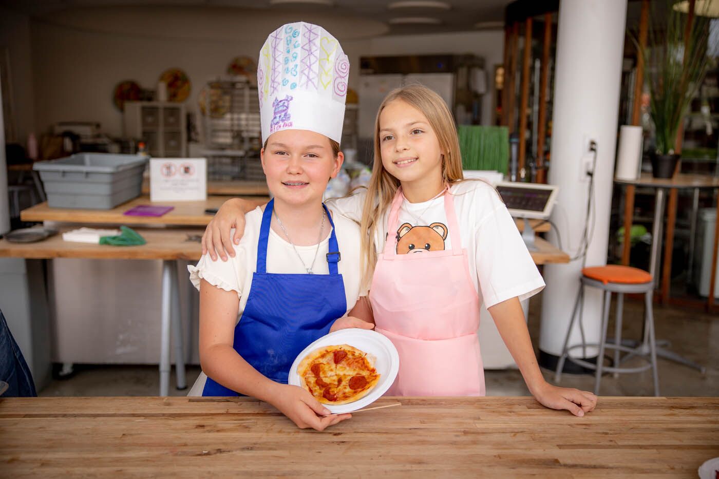 Two young girls having fun at a kids-only Valentine's class at The Real Food Academy Miami.