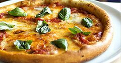 The Real Food Academy Orlando fresh made dish pizza with basil.