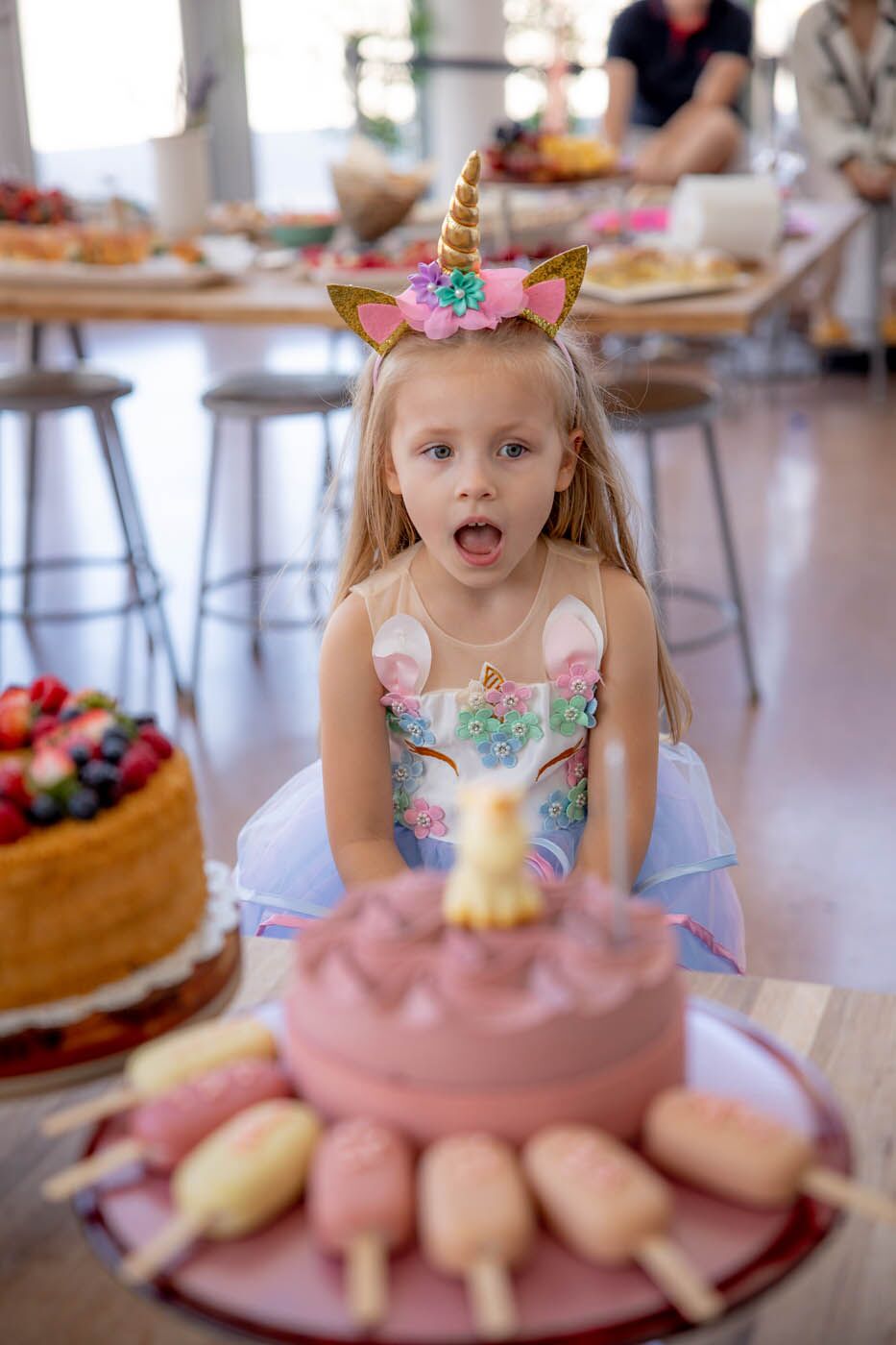 A little girl celebrating her birthday at one of The Real Food Academy's indoor birthday party venues.