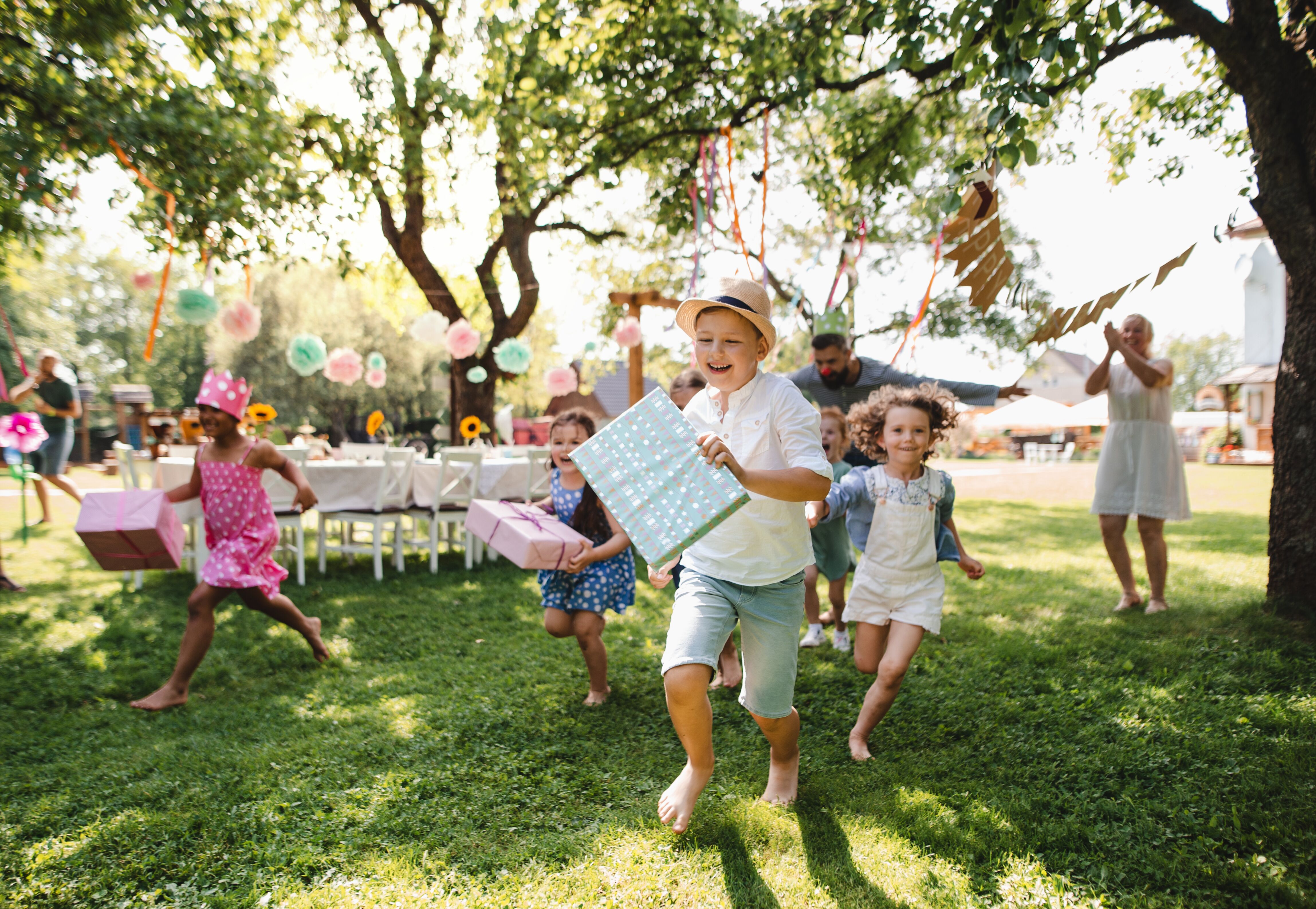 A group of kids having fun at an outdoor birthday party.