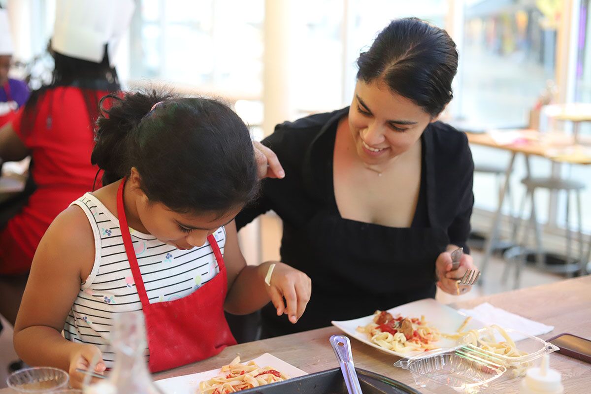 A mom and daughter cooking pasta at The Real Food Academy Miami, FL.