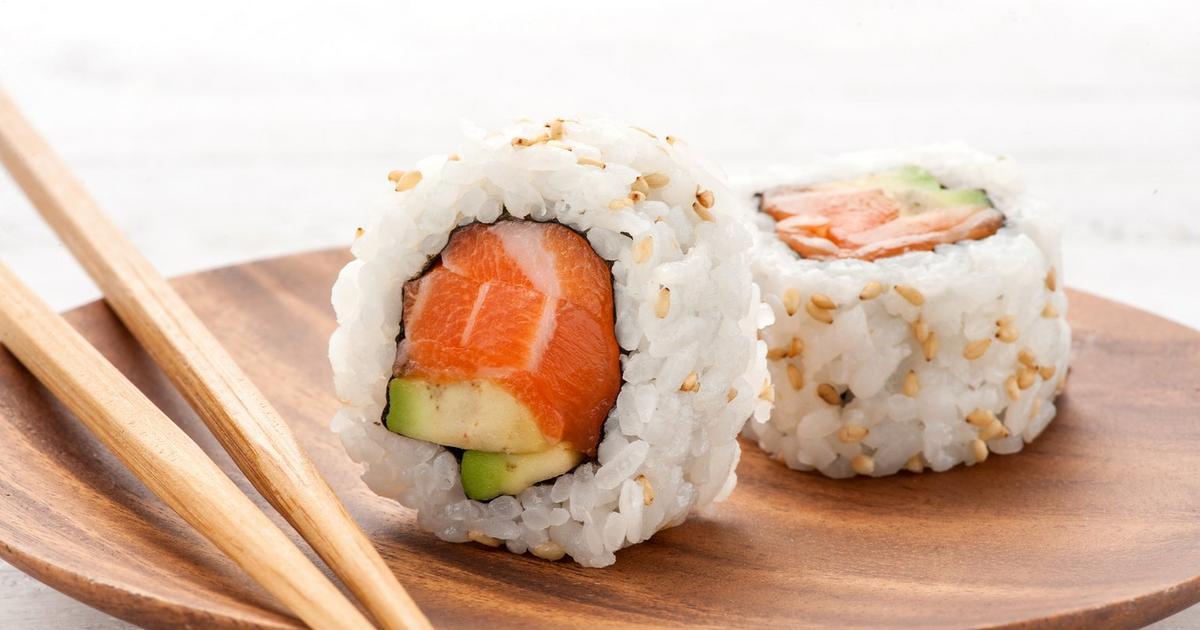 An inside out salmon roll prepared by The Real Food Academy.