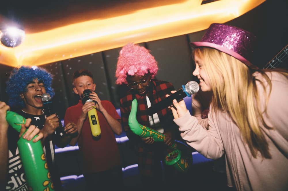 Image of kids singing with a Karaoke machine at a kids birthday party