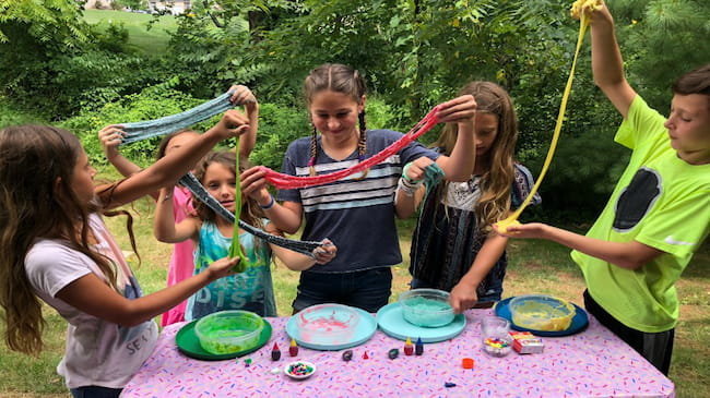 Image of kids playing with the Slime they made at a Kids Science themed birthday party