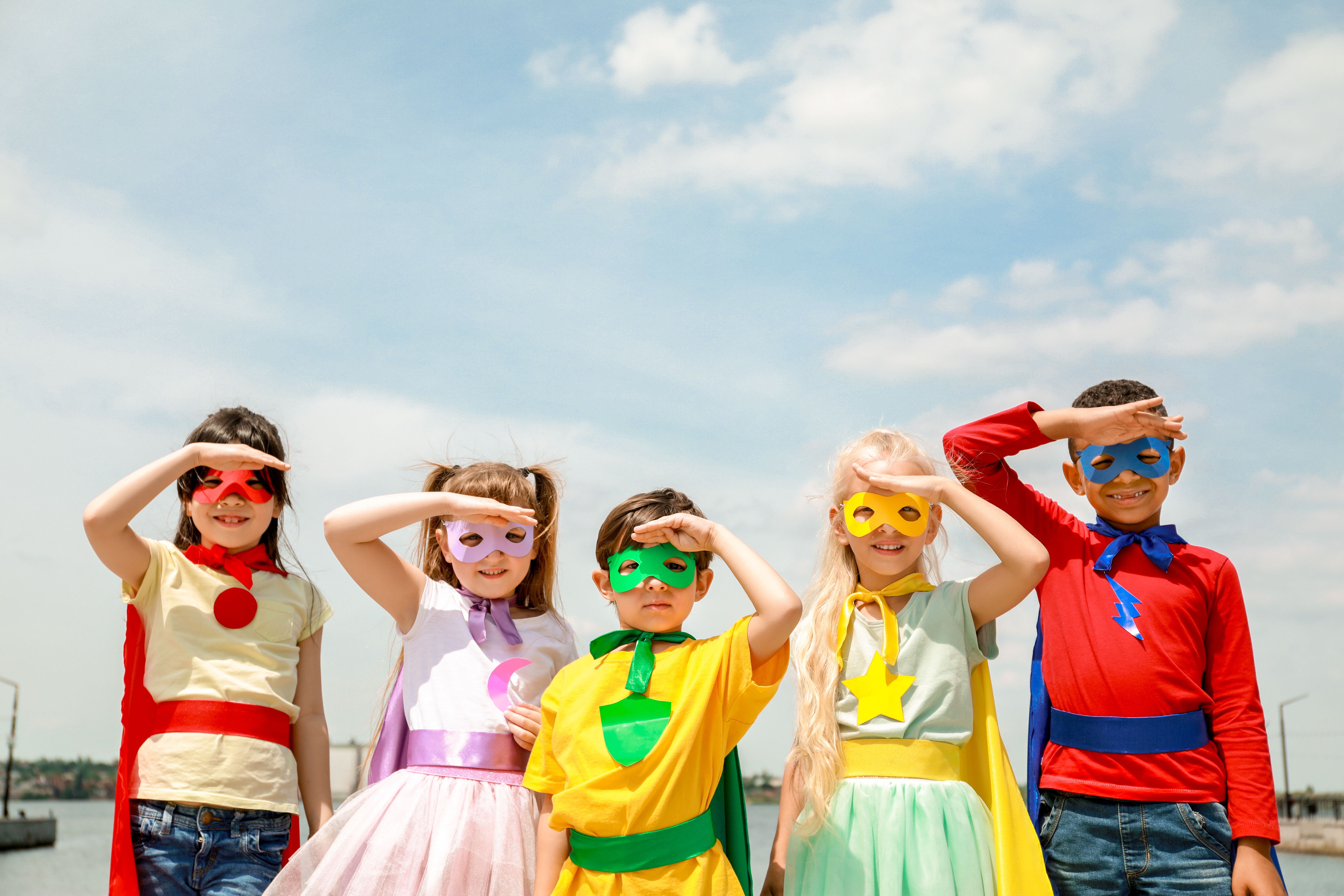 A picture of a group of children at a superhero themed birthday party, inspired by The Real Food Academy.