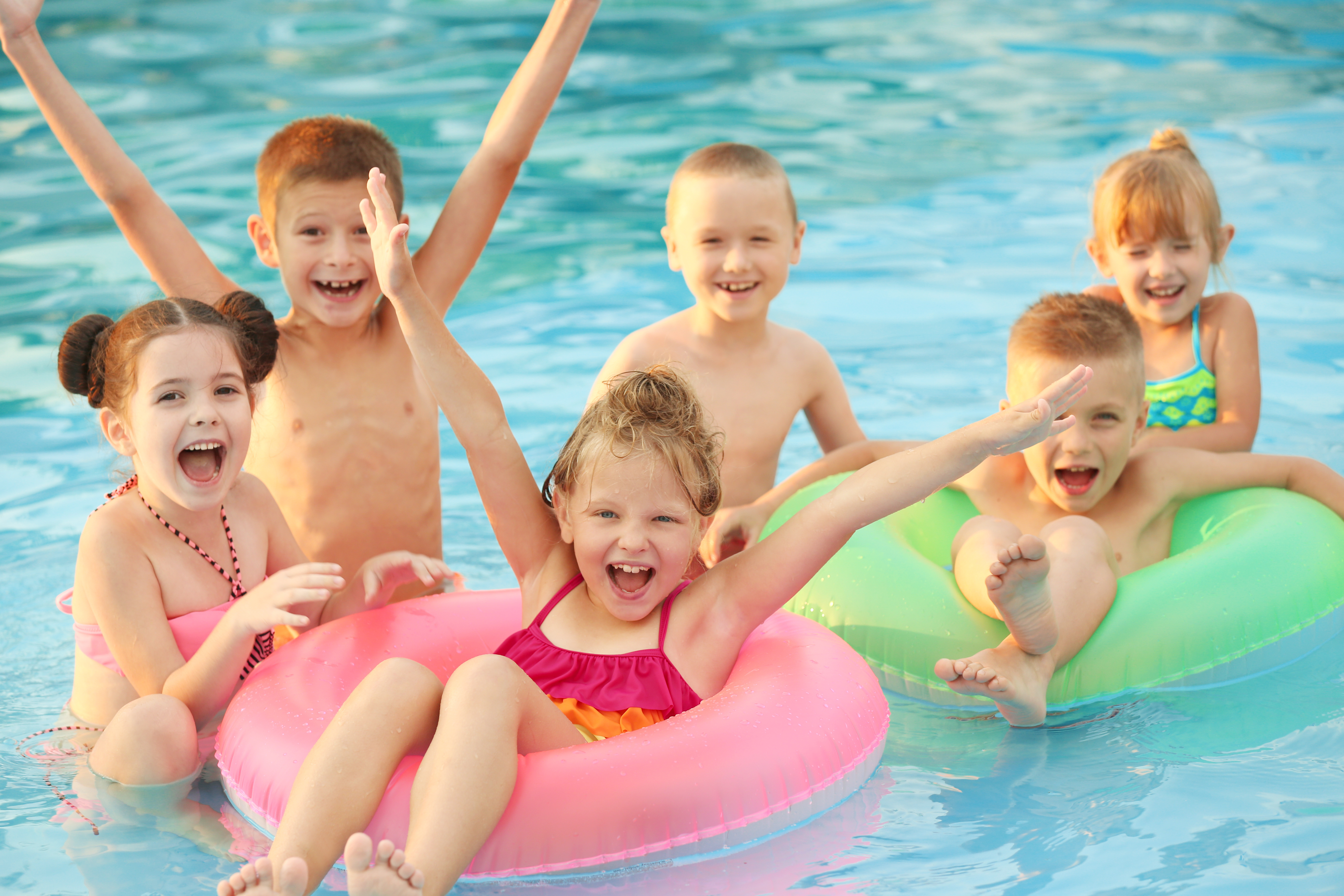 A group of children having fun at a water party.