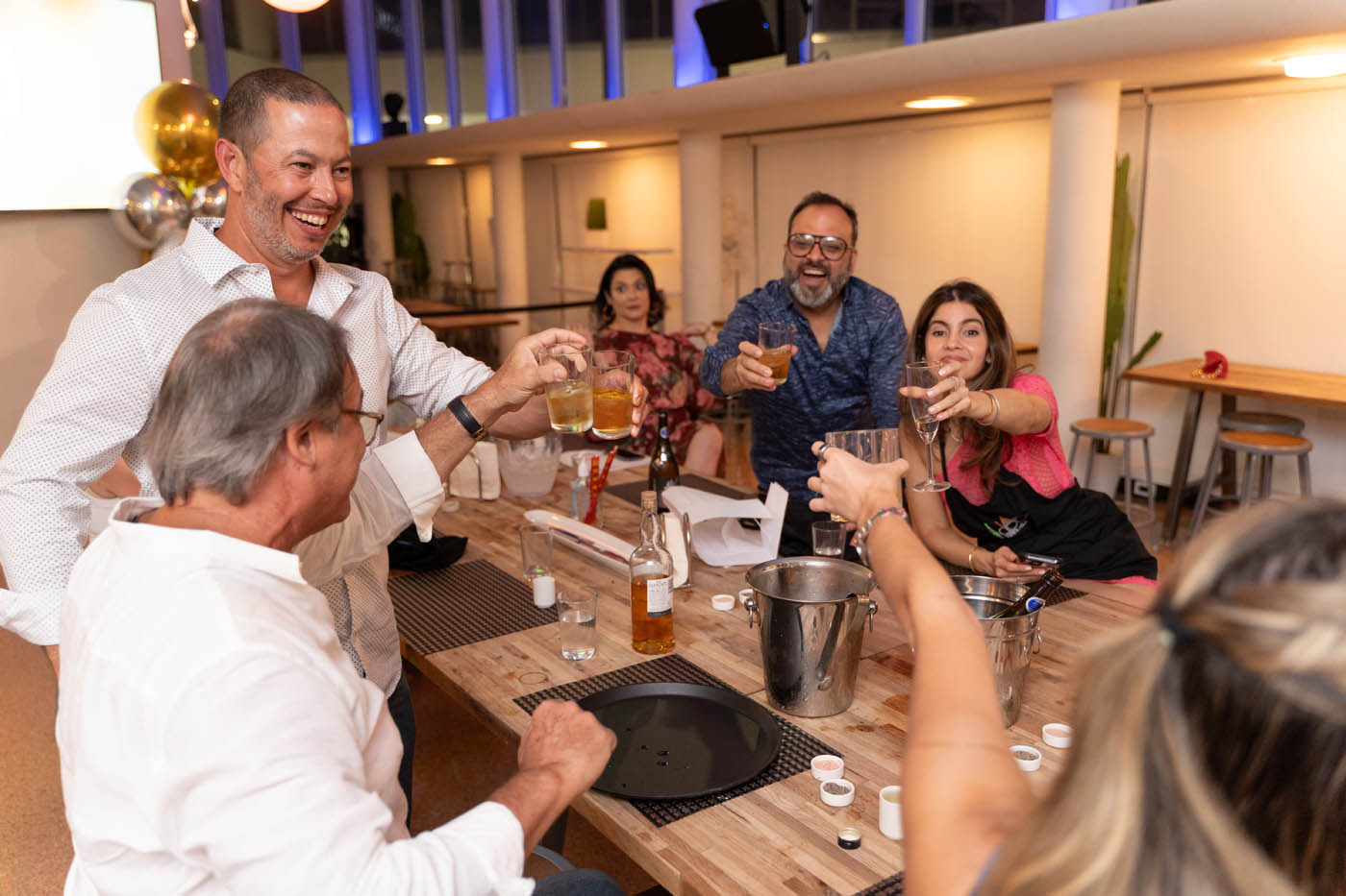 A group of adult drinking at The Real Food Academy Miami's adult birthday party venue.