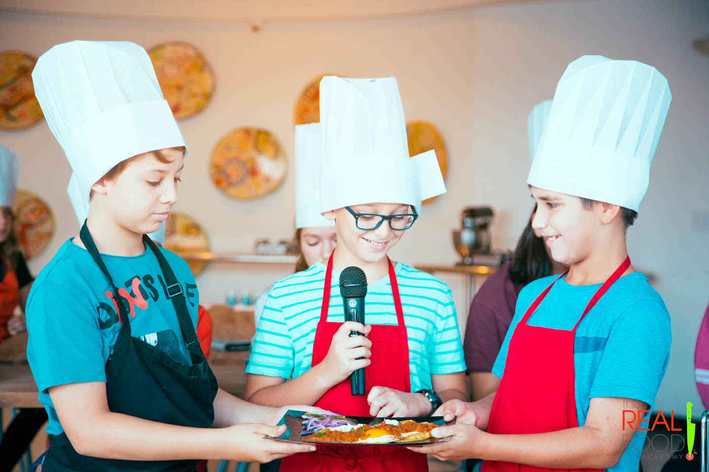 A group of younger boys presenting their creation to their peers at The Real Food Academy's summer camps for tweens in Miami, FL