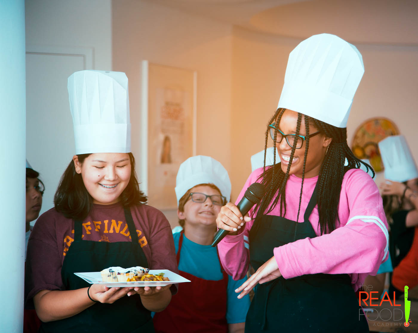 Two young girls at The Real Food Academy Miami's cooking class for teens. 