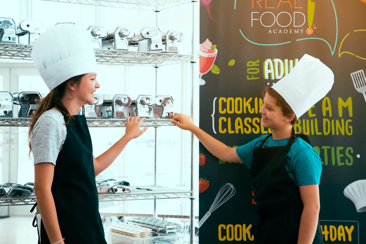 Two kids chatting at The Real Food Academy's spring break camp in Miami, FL. 