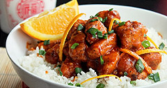 The Real Food Academy Miami orange peel chicken on white rice with vegtables.