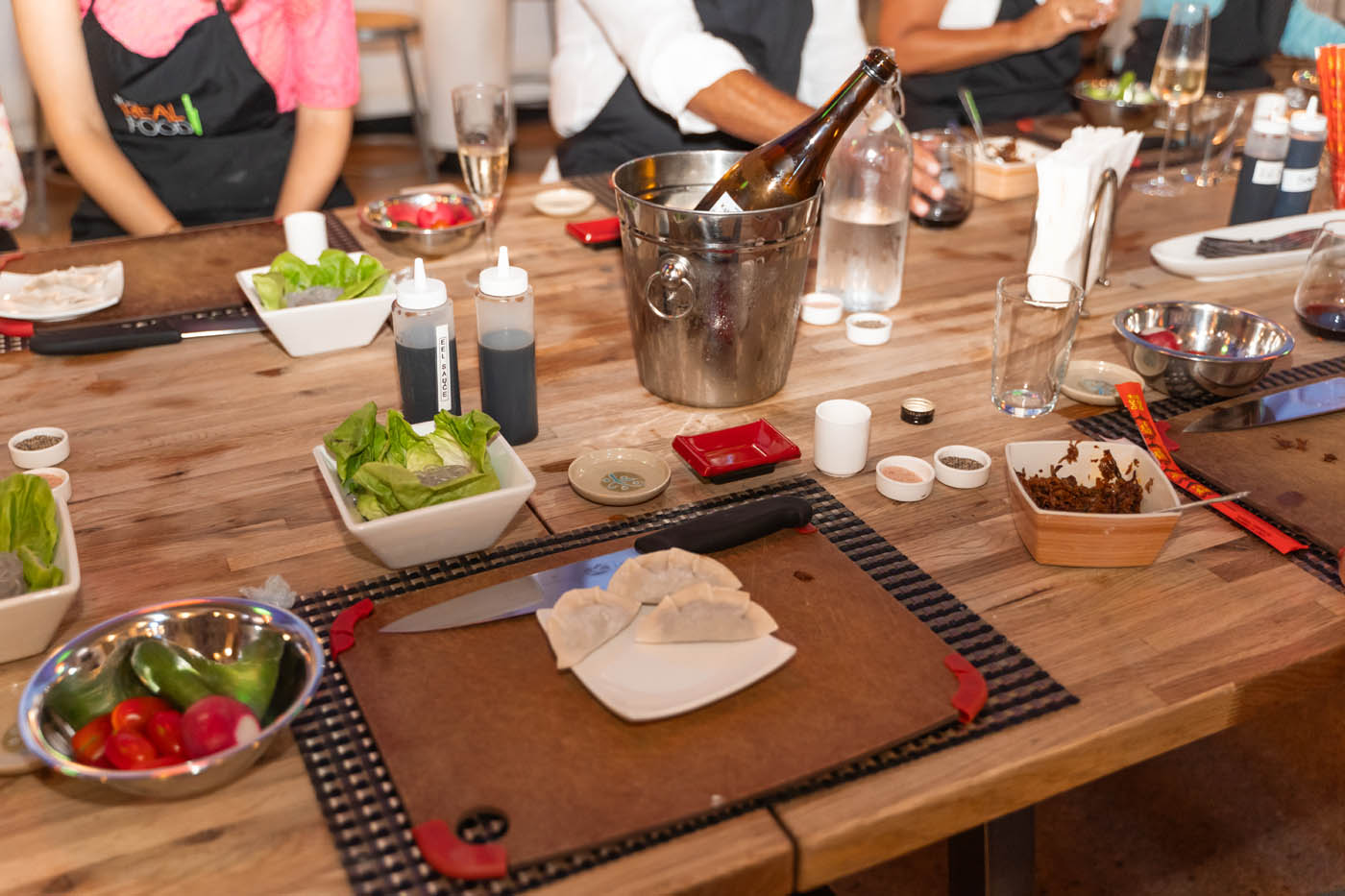 Fresh made pot stickers next to a bottle of chilled wine, try our Miami cooking classes for adults on thursdays!