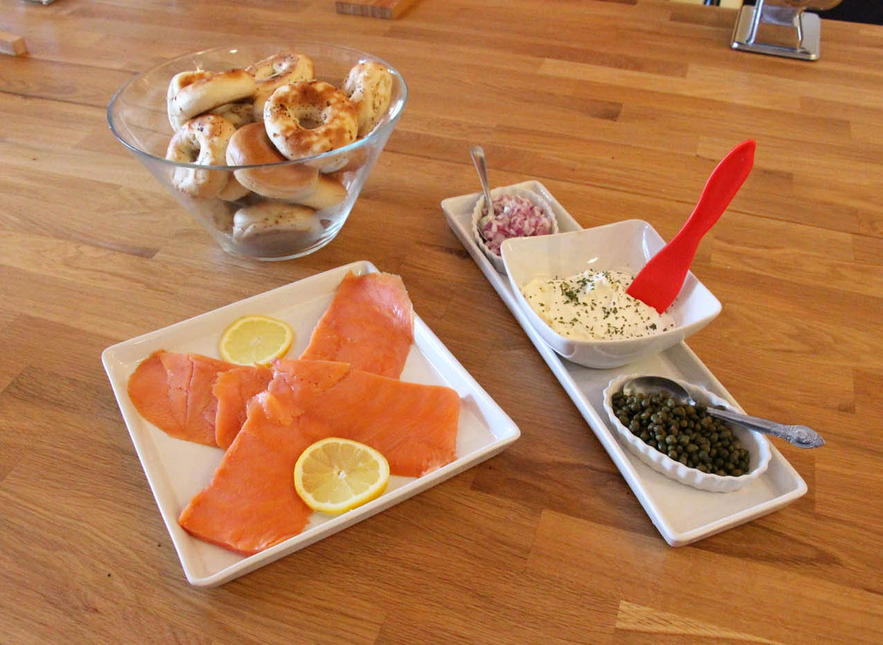 Smoked salmon with a side of capers in a white plate at The Real Food Academy.