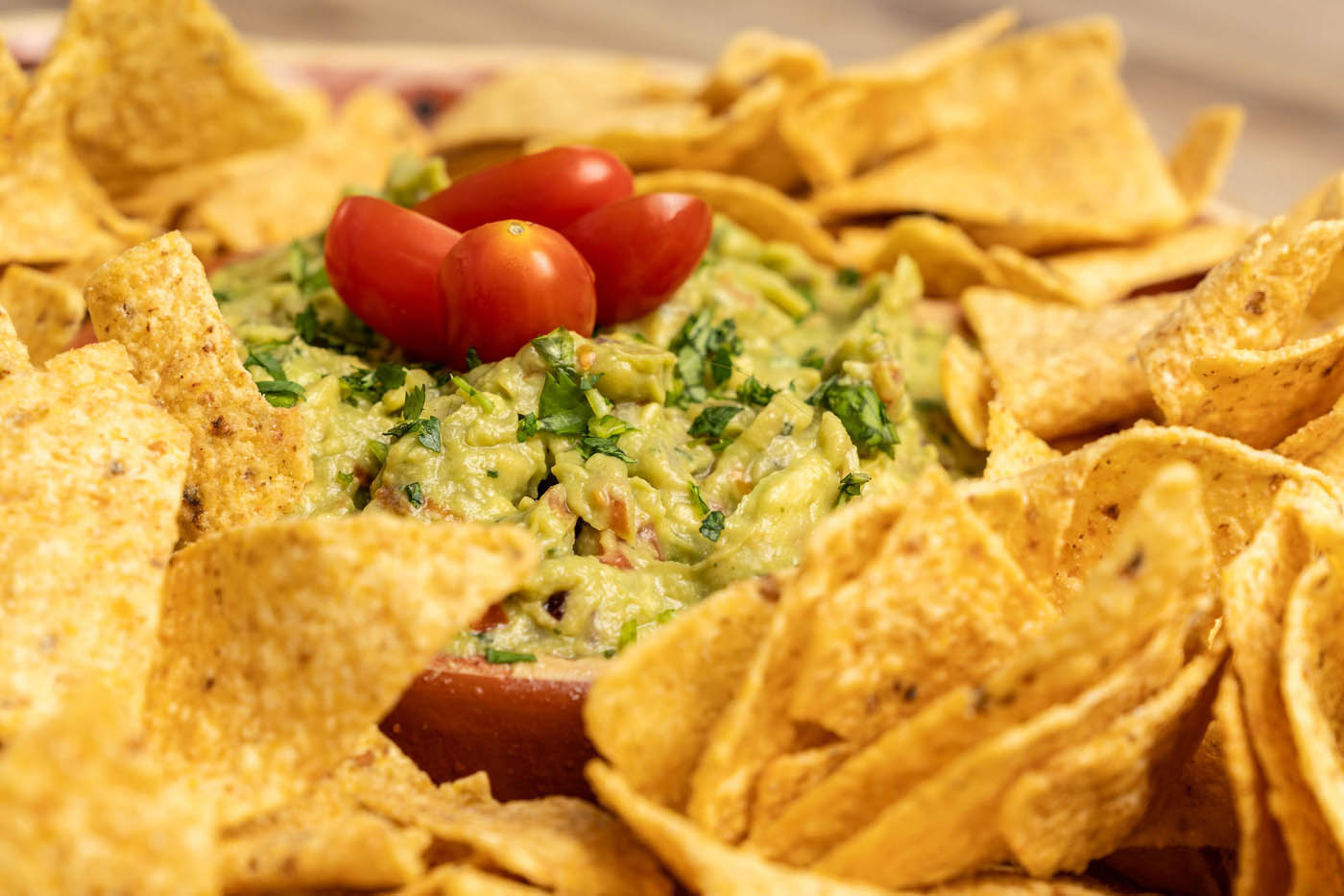 Guacamole dip with tortilla chips at The Real Food Academy Miami.