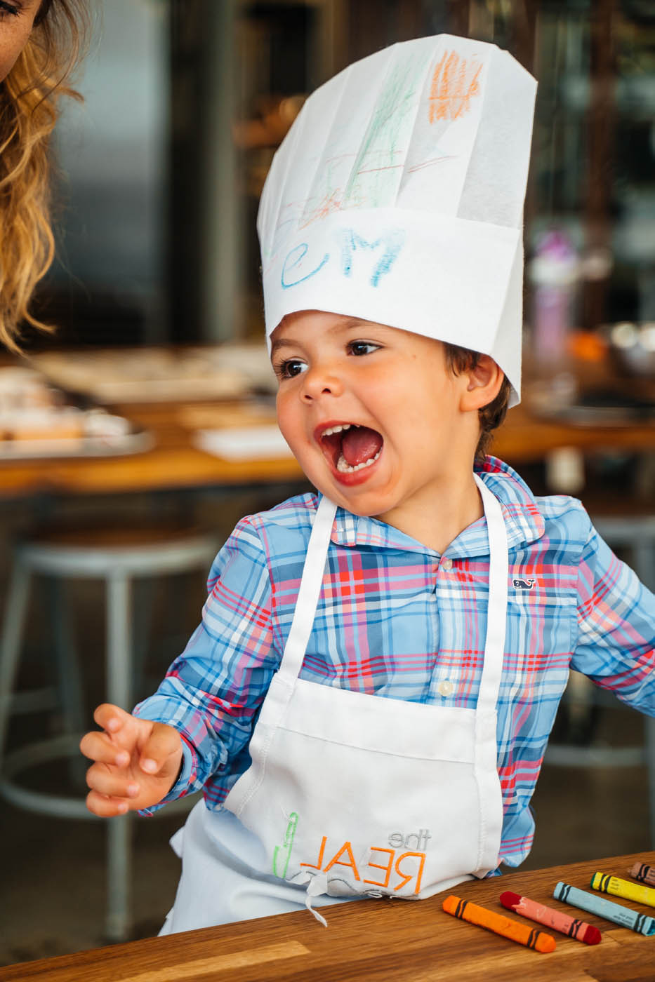 A kid enjoying all the fun offered at The Real Food Academy's cooking summer camp.
