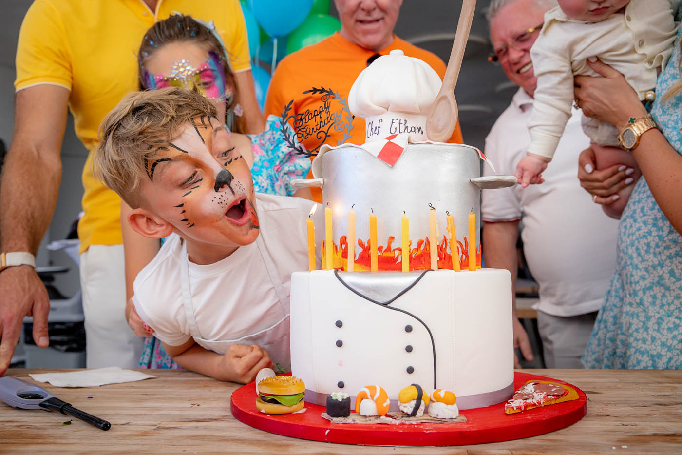A young boy celebrating his birthday with a fantastic, personalized cake.