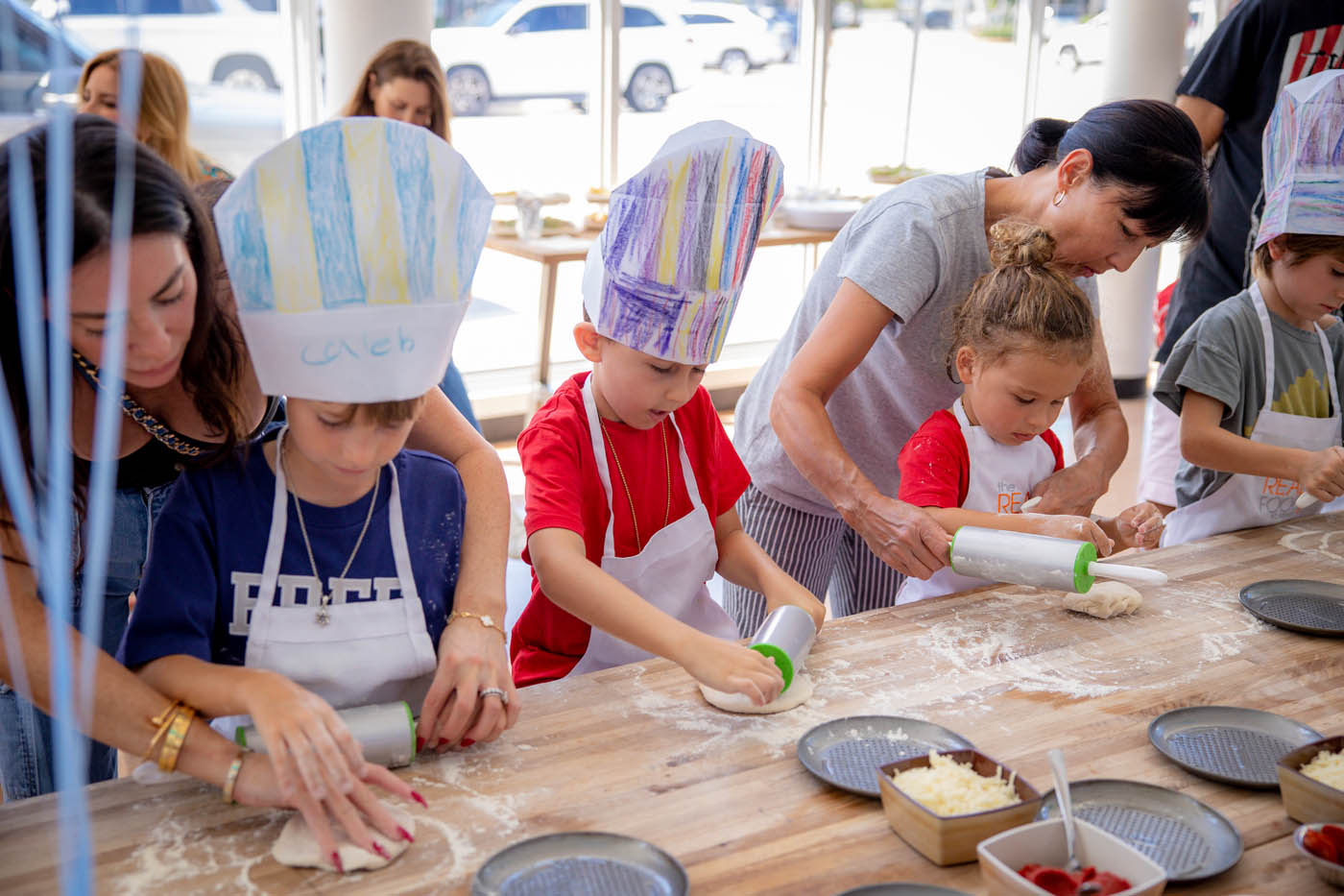 A group of children learning to cook during an indoor birthday party - Contact The Real Food Academy to book one of the best indoor birthday party places.