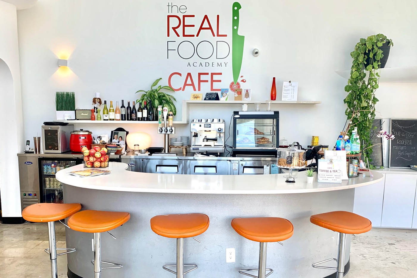 The Real Food Academy bar with orange chairs.